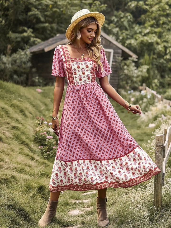 Woman wearing Pink Bohemian Maxi Dress with ruffled, floral print | Lunova