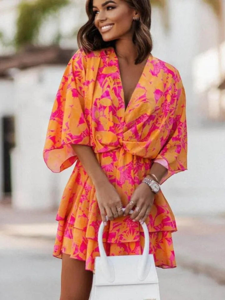 Woman wearing Orange Floral Ruffle Mini Dress with A-line, empire-waist | Lunova