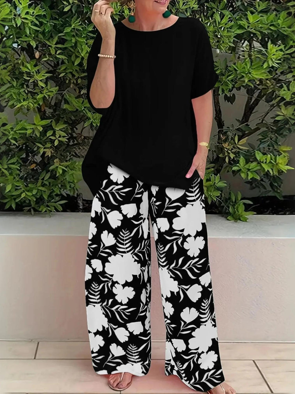 Woman wearing Black Floral Two-Piece Set with wide-leg | Lunova