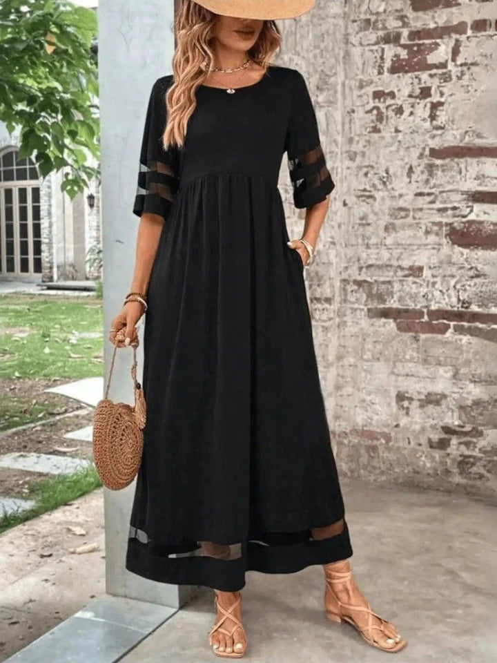 Woman wearing Black Sheer-Trim Maxi Dress with empire-waist, flowing | Lunova