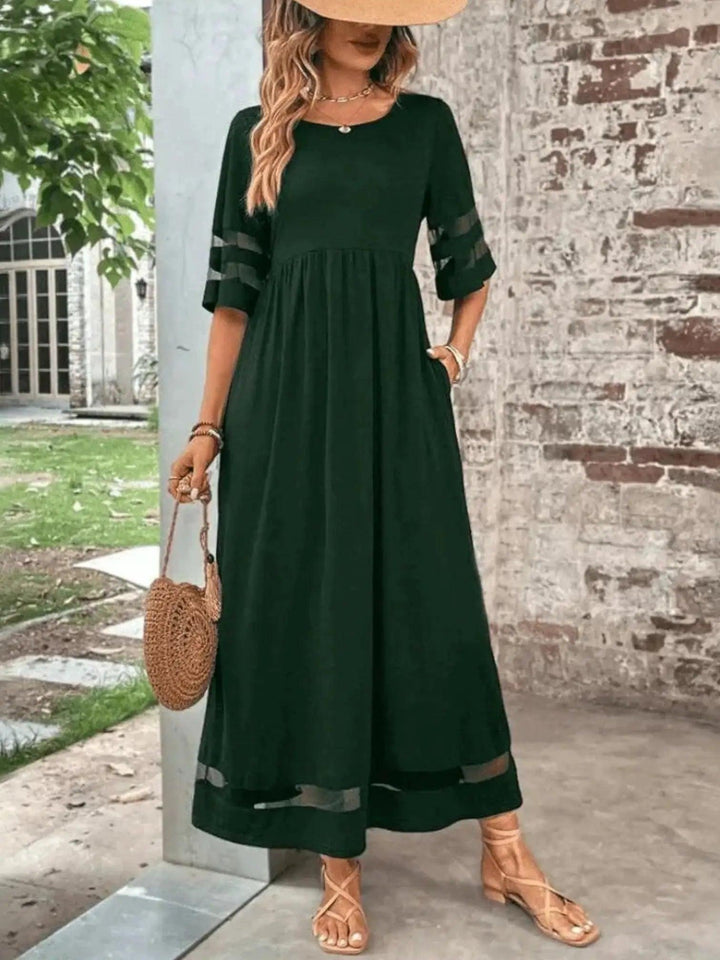 Woman wearing Green Sheer-Trim Maxi Dress with empire-waist, flowing | Lunova