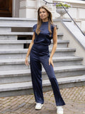 Woman wearing Shoulder Pad Jumpsuit with sleeveless, wide-leg | Lunova