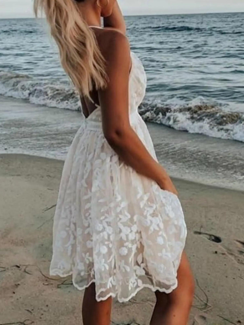 Woman wearing Sleeveless Lace Mini Dress with empire-waist, V-neck — view 2 | Lunova