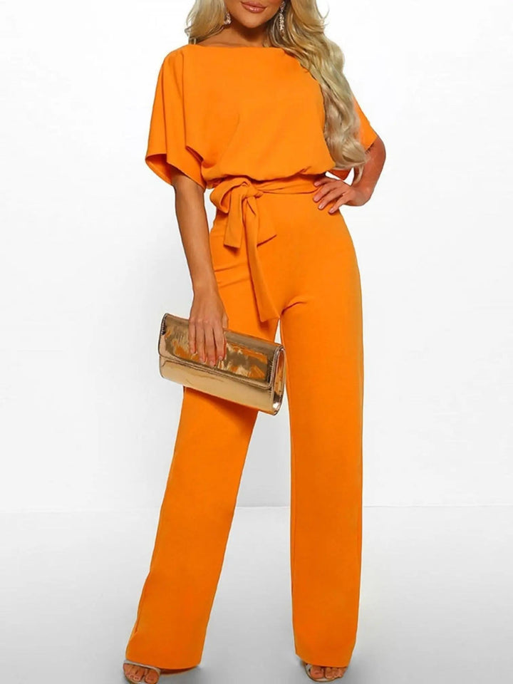 Woman wearing Orange Waist Tie Jumpsuit with full-length, wide-leg | Lunova