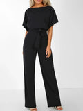 Woman wearing Black Waist Tie Jumpsuit with full-length, wide-leg | Lunova